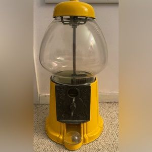 Yellow gum ball machine.Some nicks on it.Can be seen in picture some go around.